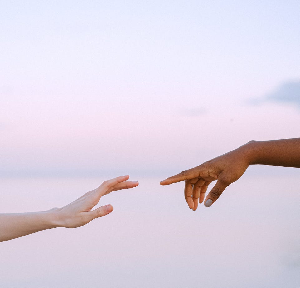 Photo Of People Reaching Each Other's Hands